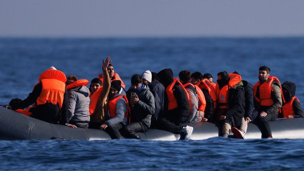 Migrants on a small inflatable boat in the English Channel. 