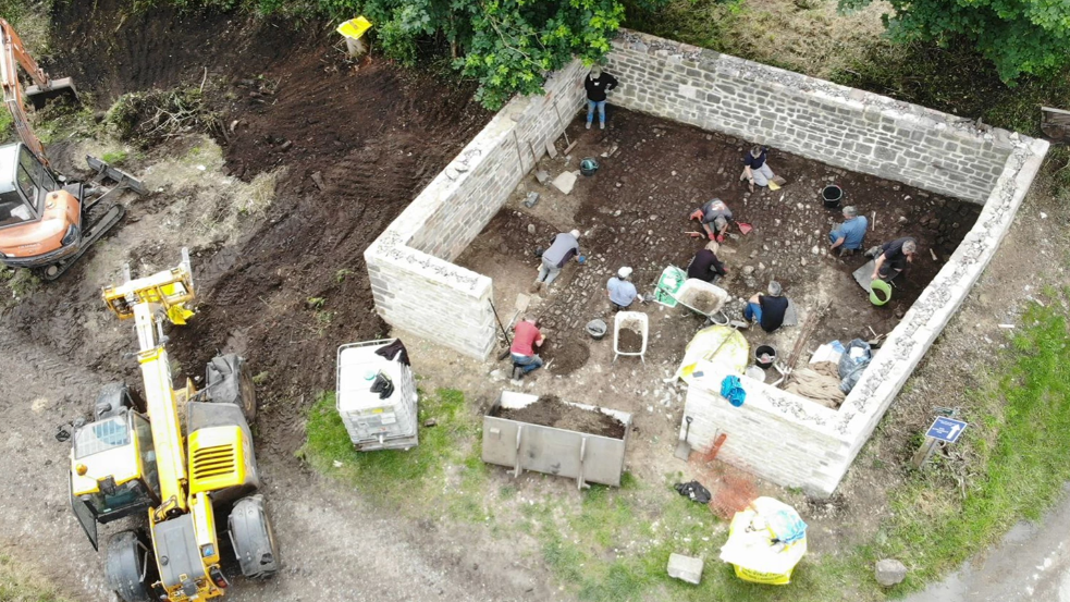 An aerial view of the pound being restored with heavy machinery nearby