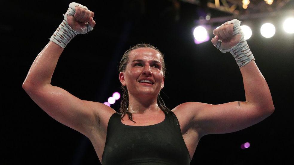 Chantelle Cameron celebrates after a win, with her hands raised in the air