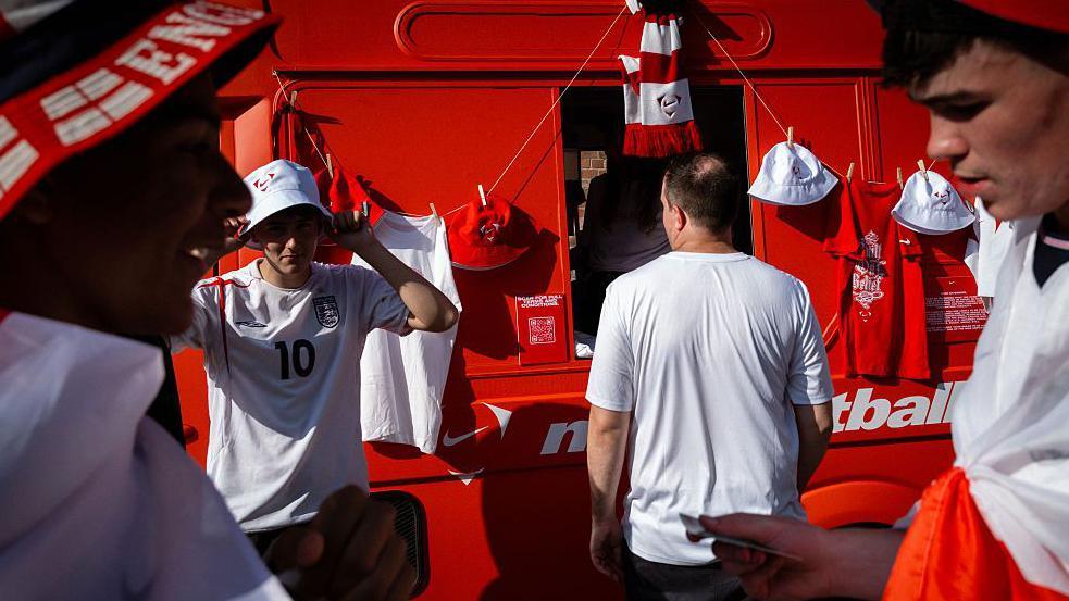 England fans collect merchandise before the highly anticipated World Cup semi-final.
