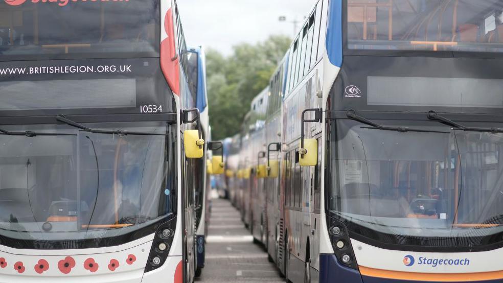 Two rows of Stagecoach buses trailing away from the camera.