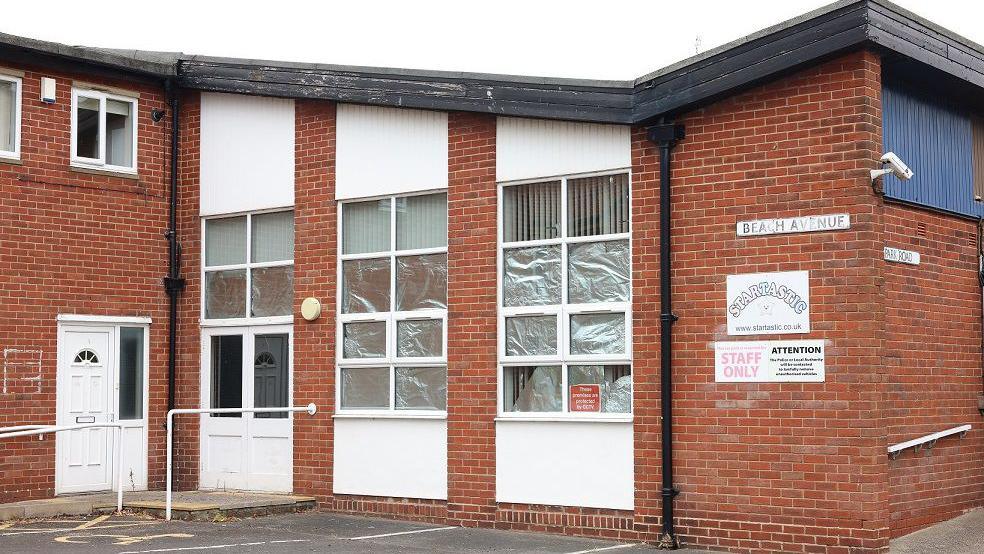 The former Startastic building in Whitley Bay, which features brickwork and white panelling. 