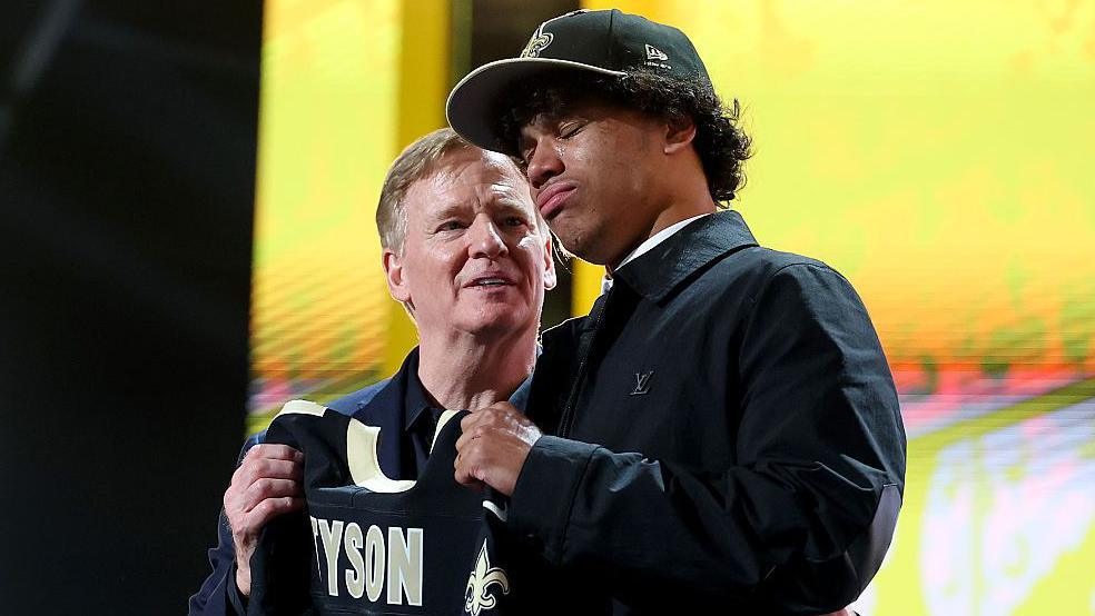 NFL Commissioner Roger Goodell holding a jersey with Jordyn Tyson after he was selected by the New Orleans Saints at the 2026 NFL Draft