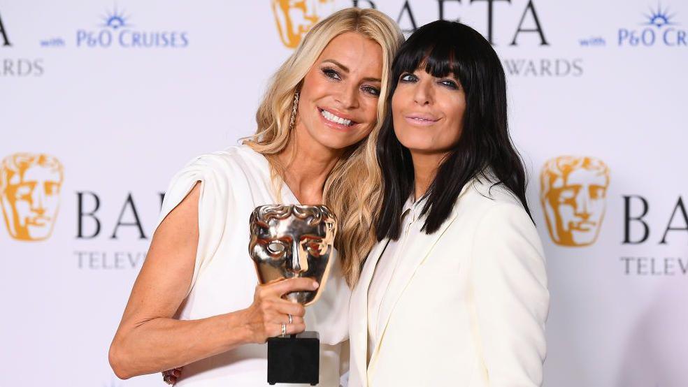 Tess Daley and Claudia Winkleman posing together.