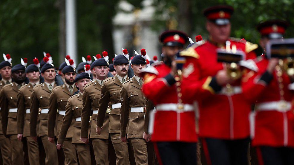 Members of the armed forces parade down The Mall, in central London on May 5, 2025 during an armed forces procession