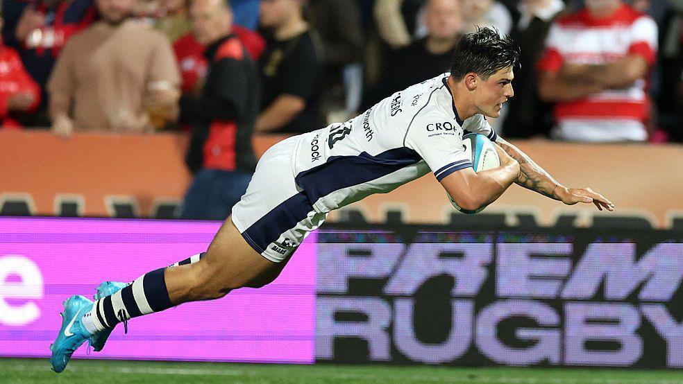 Louis Rees-Zammit dives over to score for Bristol at Gloucester in the Prem Rugby Cup