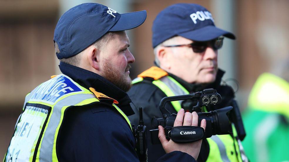  A police spotter is seen recording fans during the Sky Bet League One match between Oxford United and Reading at Kassam Stadium on February 03, 2024 in Oxford, England. 