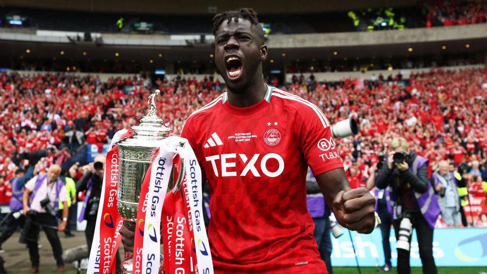 Pape Gueye celebrates with the Scottish Cup at Hampden
