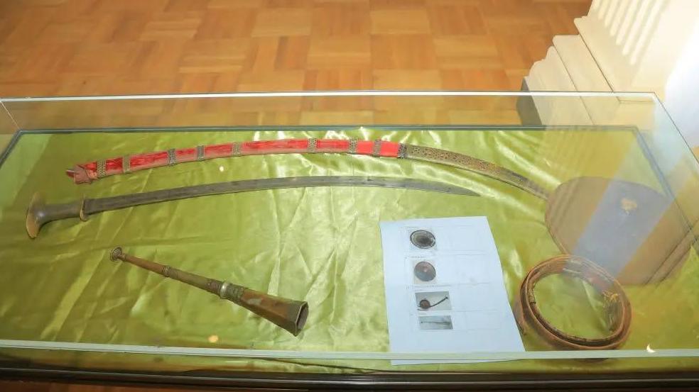 A display of historical shields and a paper with their prints 