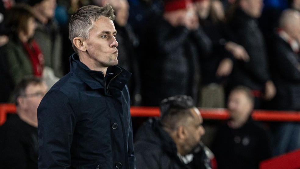 Kieran McKenna stands deep in thought on the touchline