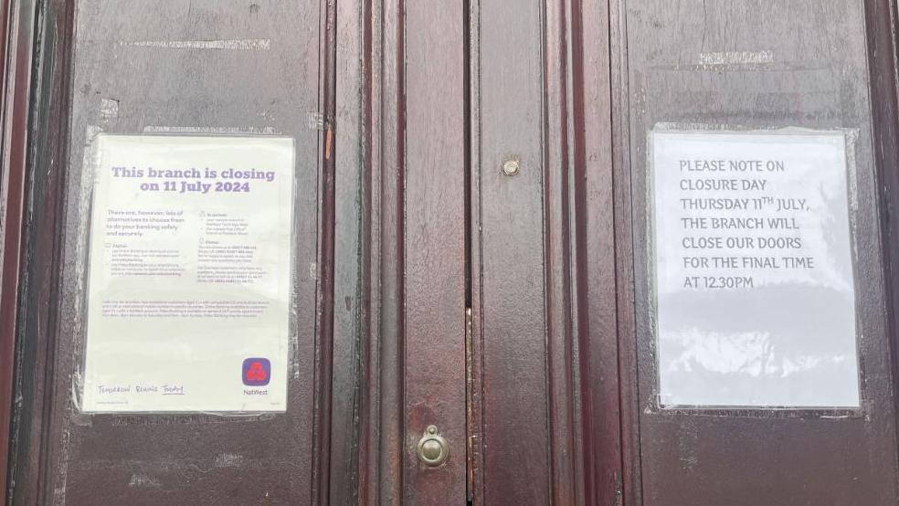 Two signs on the door of NatWest outlining the July 11th closure