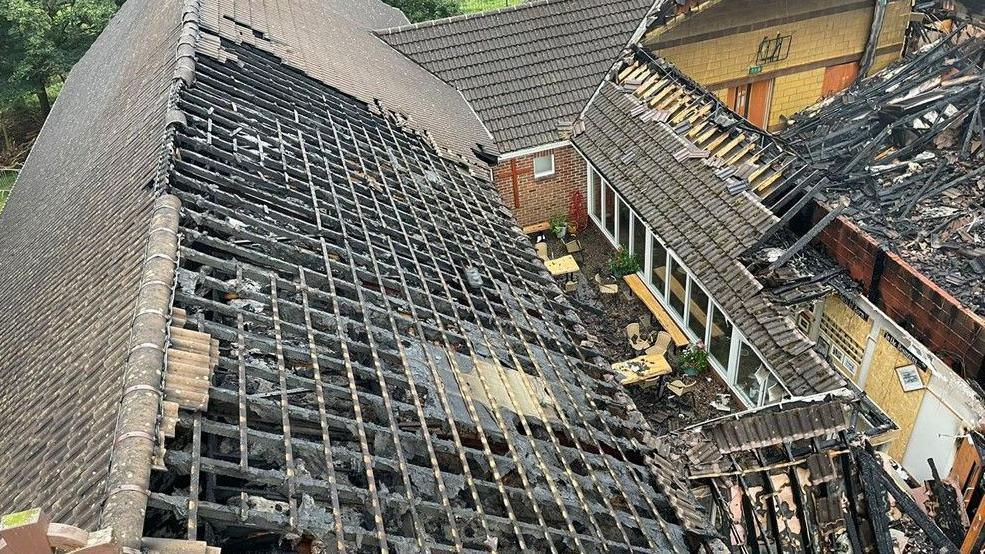 Fire damaged church aerial photo showing missing roof