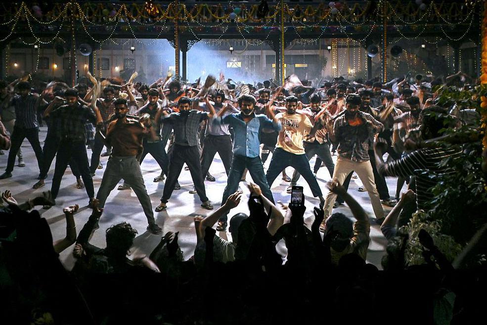Fans dance inside a theatre during the screening of Indian actor Rajinikanth's new Tamil-language movie 'Coolie' on the first day of its release in Mumbai