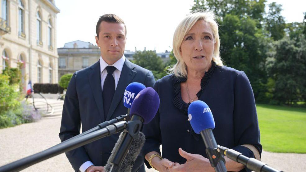 President of the French far-right party Rassemblement National (RN) and MEP Jordan Bardella (L) stands next to French Member of Parliament and French far-right Rassemblement National (National Rally) RN party's leader Marine Le Pen (R) 