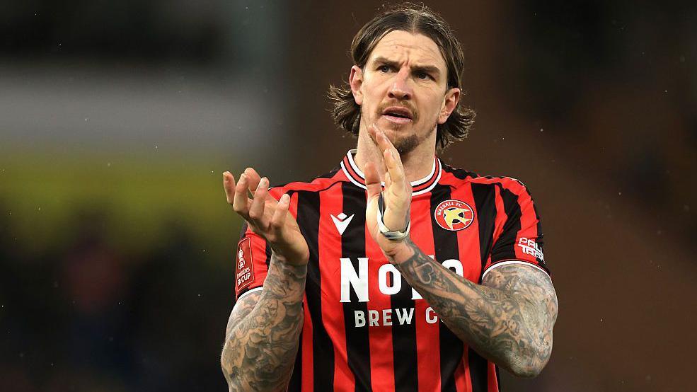 Aden Flint claps the Walsall fans after a game