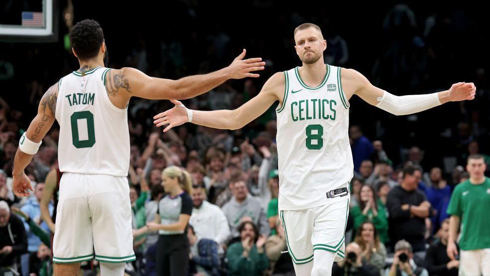 Kristaps Porzingis celebrates with Jayson Tatum after scoring