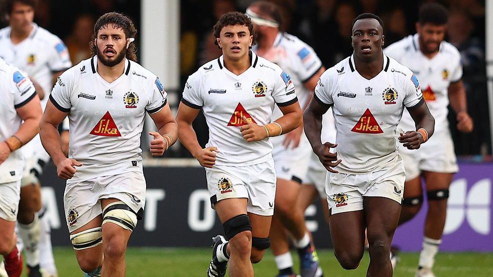 Exeter Chiefs players run on the pitch