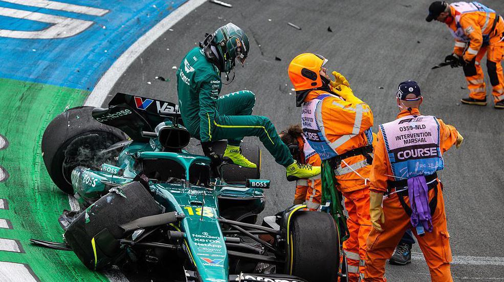 Lance Stroll climbs out of his damaged Aston Martin after crashing at Turn Three during Dutch Grand Prix second practice
