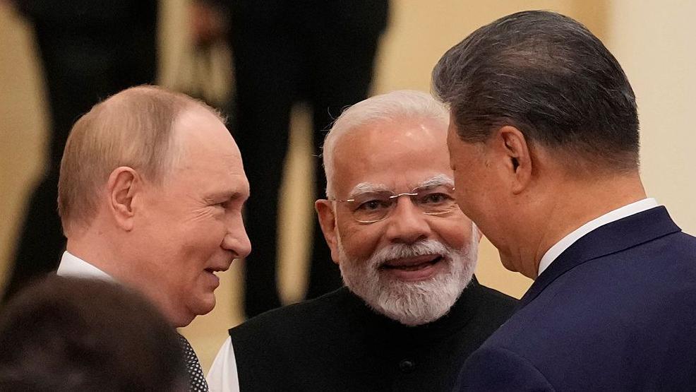 Indian Prime Minister Narendra Modi talks with Russian President Vladimir Putin (L) and Chinese President Xi jinping (R) ahead of the Shanghai Cooperation Organisation (SCO) Summit 2025 in Tianjin, China.
