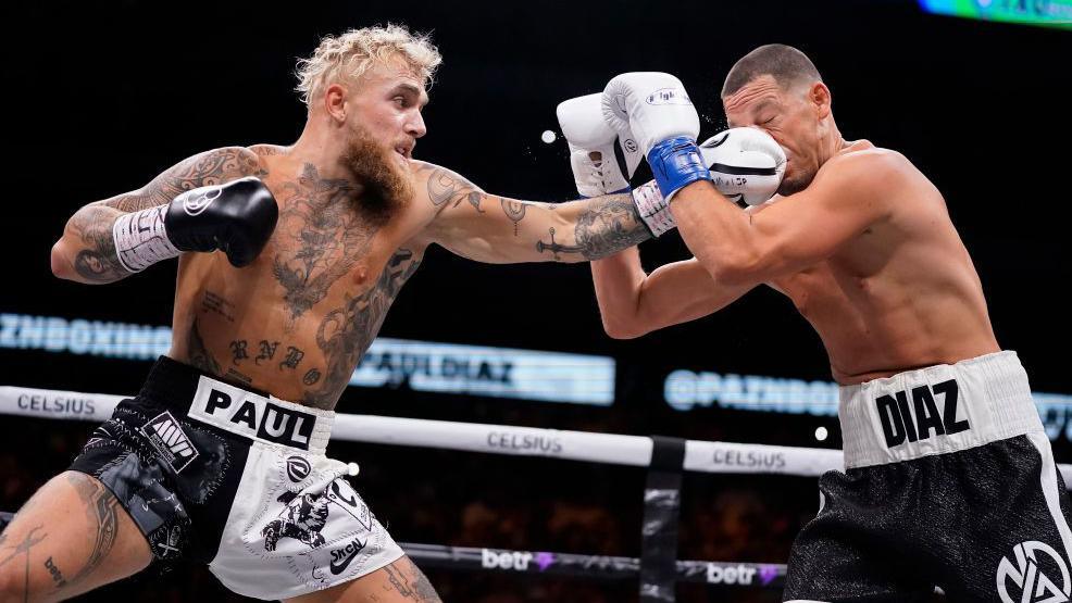 Jake Paul aims a punch at Nate Diaz in a boxing match