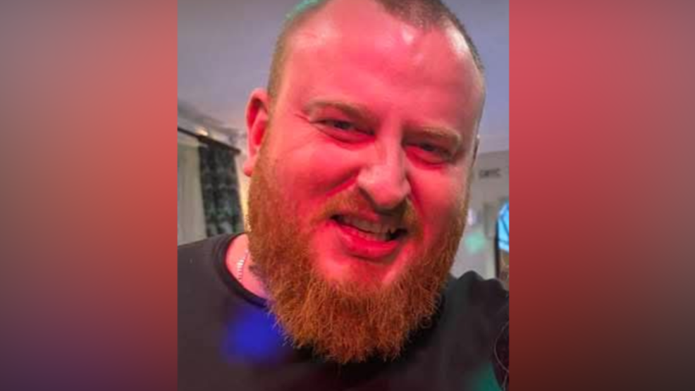 Shane Cullen, with an ginger beard and close-cropped hair, smiles for the camera