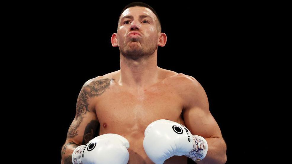 Liam Williams with white gloves in the ring