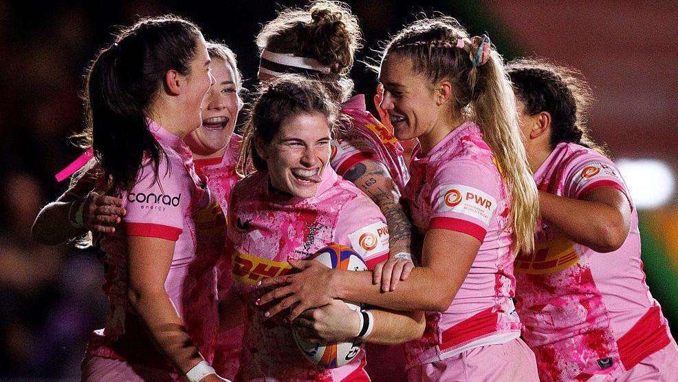 Claudia Pena is mobbed by her teammates after scoring a try for Harlequins