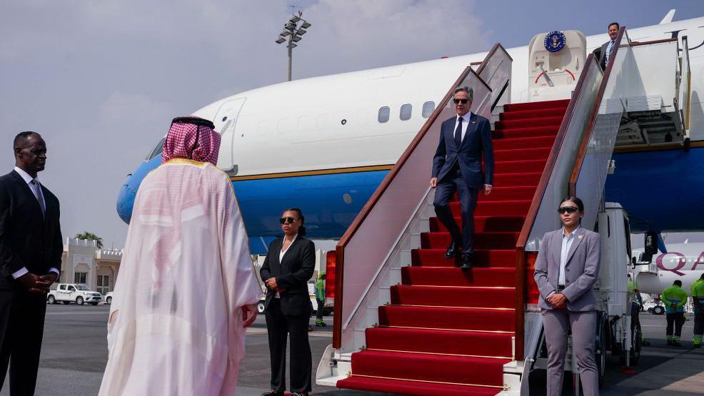 The US secretary of state, Antony Blinken exits a plane and walks down stairs as he arrives in Doha on a recent visit to Qatar