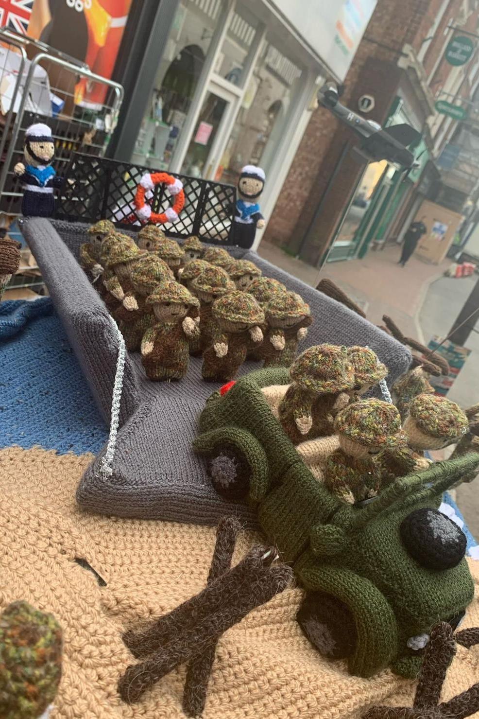 Knitted scenes from D-Day on top of a postbox