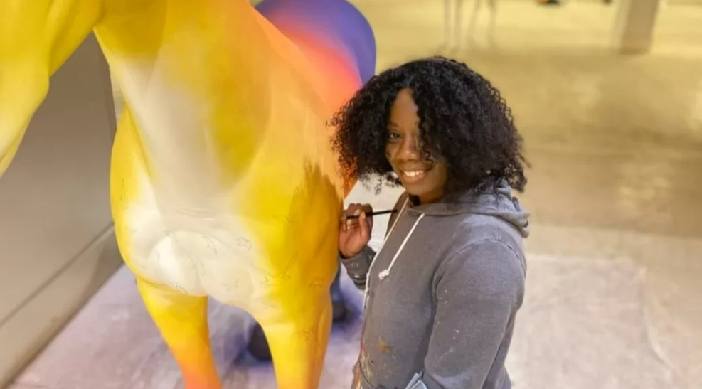 A woman painting a unicorn