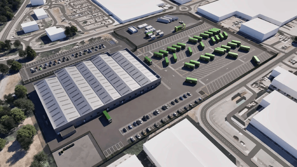 A CGI image of how the new bus depot could look. Large industrial buildings can be seen as well as a fleet of green buses in a car park.