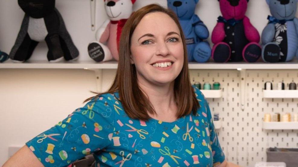 A woman smiles in a home