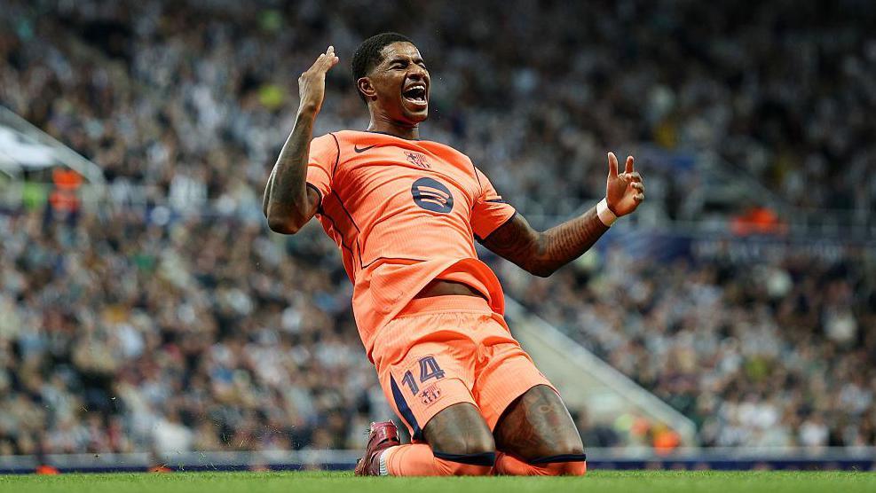 Marcus Rashford celebrates on his knees after scoring for Barcelona