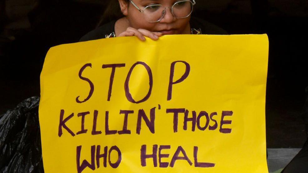 A junior doctor protesting against  the murder of a woman postgraduate trainee doctor at state-run RG Kar Medical College in Kolkata