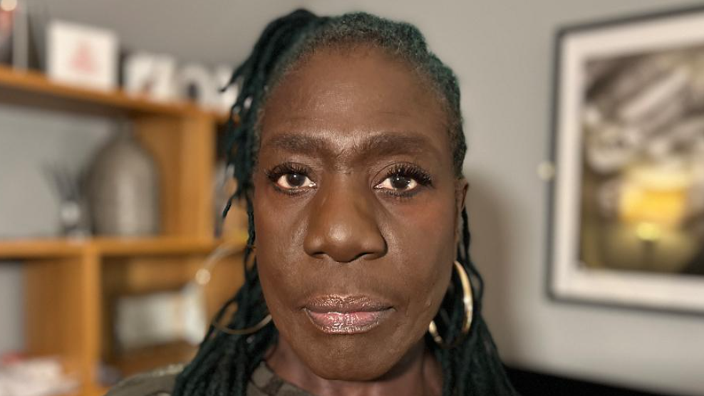 A black woman looking straight into the camera