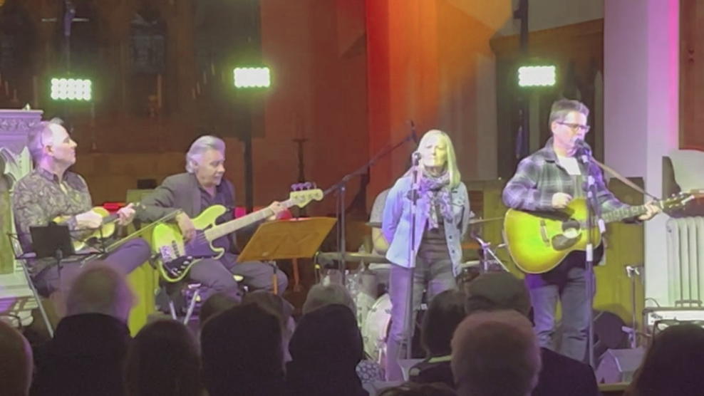 Glen Matlock and Kevin Brennan performing on stage with another woman and man