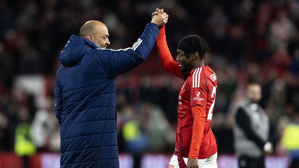 Nottingham Forest's manager Nuno Espirito Santo celebrates victory at the end of the match against Manchester United with Anthony Elanga 