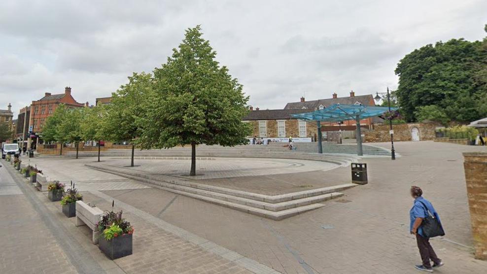 Paved market place with planters and trees