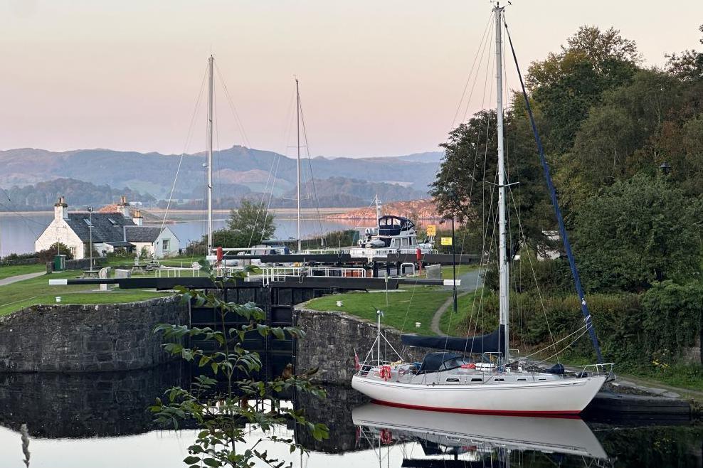 A yacht, house and canal locks at Crinan Basin 