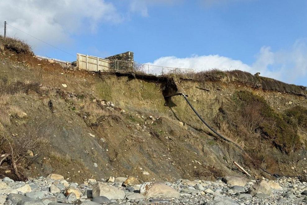 A view from the beach below the clifftop home showing how the side of the cliff has collapsed