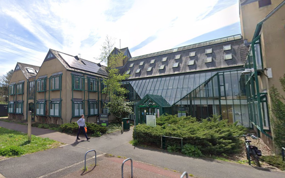 Teignbridge District Council building. The building is cream with green window panes.