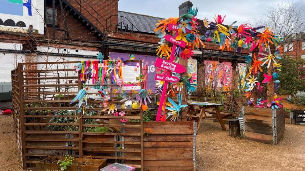 Benches and planters at Electric Daisy, which are colourfully decorated. 