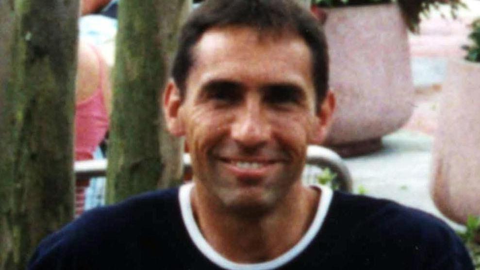 DC Stephen Oake has dark short hair and a black T-shirt with a white collar.