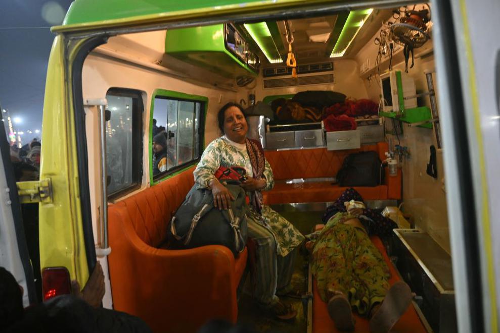 A devotee weeps as she sits in an ambulance at the site of stampede amid the ongoing Maha Kumbh Mela festival in Prayagraj on January 29, 2025.