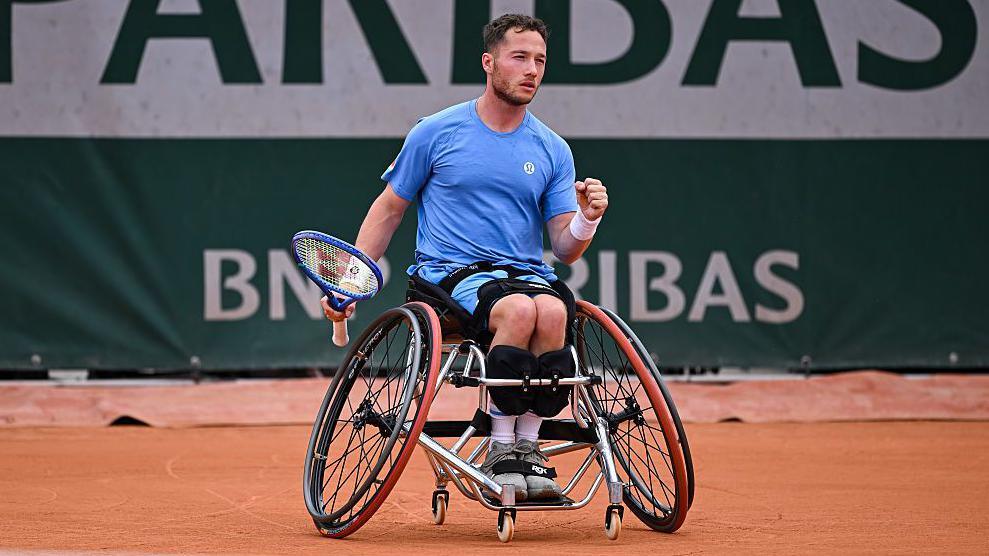 Alfie Hewett holds up his fist in celebration