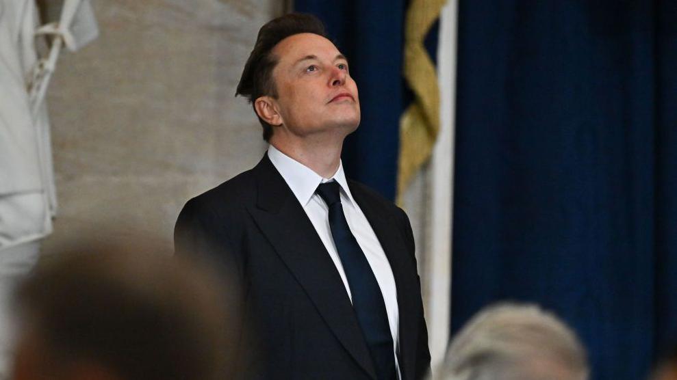 Elon Musk at Donald Trump's inauguration wearing a suit and tie