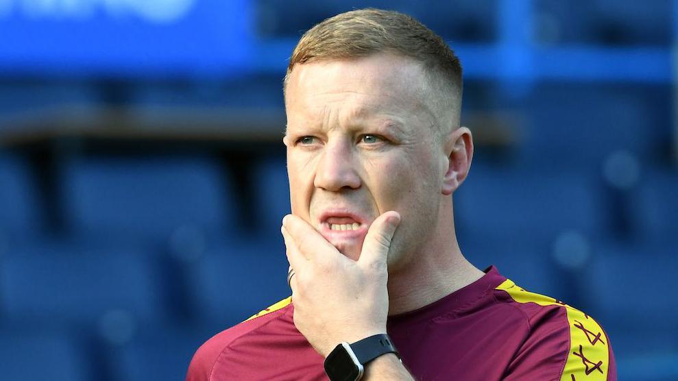 Luke Robinson pondering whilst interim head coach of Huddersfield Giants before their match against Warrington Wolves in September 2024