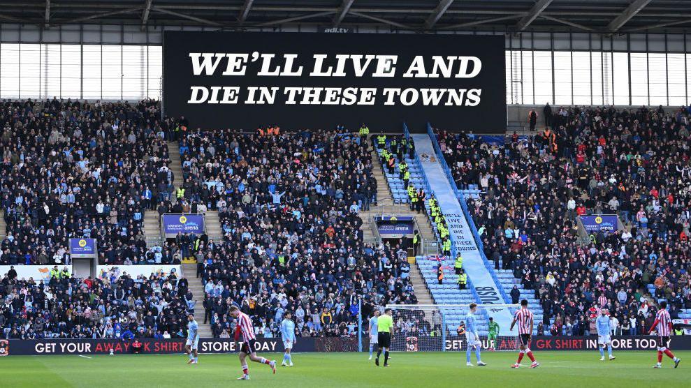 "We'll Live and Die in These Towns" displayed by a banner inside the CBS Arena, during Coventry's match against Sunderland.