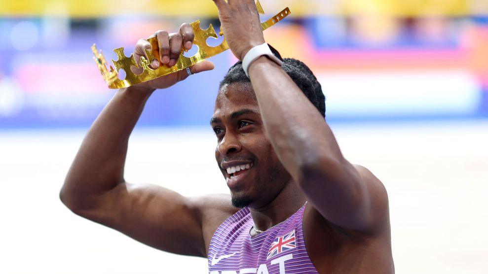 Jeremiah Azu celebrates with a gold crown