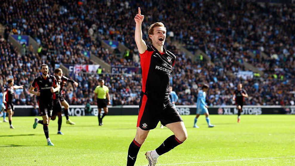 Flynn Downes celebrates pointing up after opening the scoring